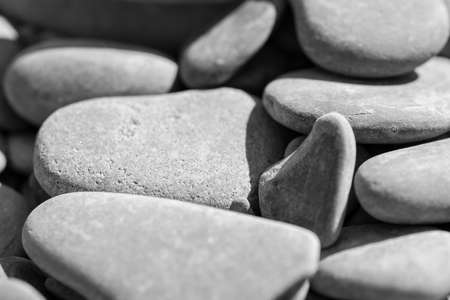 sea pebbles close-up in sunlight. Close-up of multicolored pebbles on the sea beach in the sunlightの写真素材