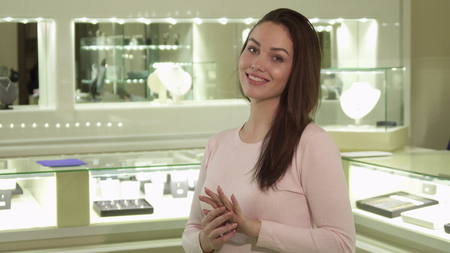 Woman tries on the ring at the jewelry boutiqueの写真素材