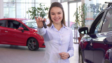 Woman buys new car at the dealershipの写真素材