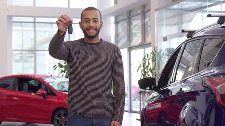 Guy holds car key in his handの写真素材