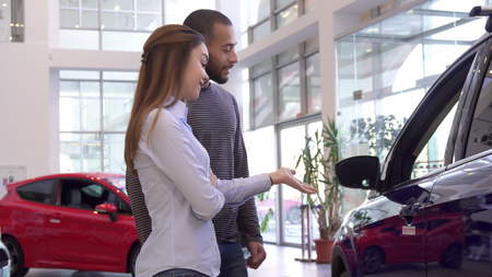 Couple chooses car at the dealershipの写真素材