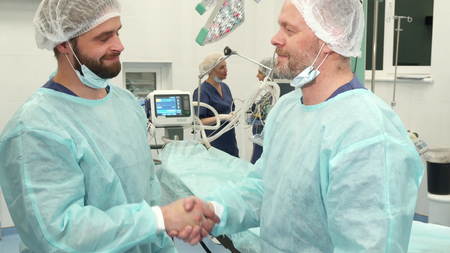 Surgeons shake their handsの写真素材
