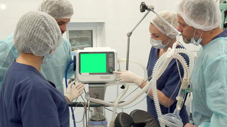 Surgical team discussing something on monitorの写真素材