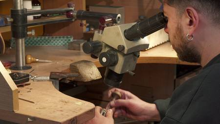 Jeweler looks through the microscopeの写真素材