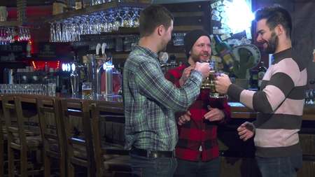 Friends drink beer at the pubの写真素材