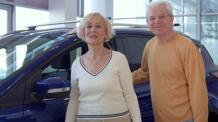 Senior couple chooses car at the dealershipの写真素材