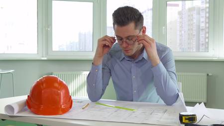 Architect takes off his glassesの写真素材