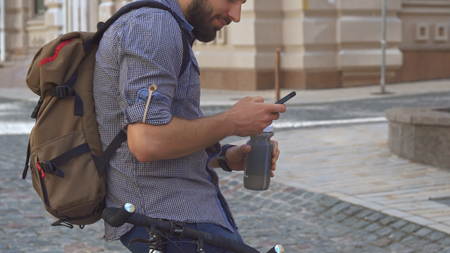 Cyclist drinks water on his bicycleの写真素材