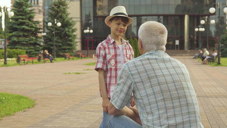 Senior man highfives with his grandsonの写真素材