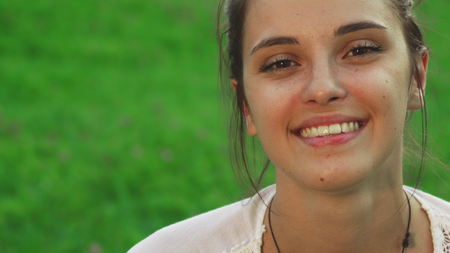 Beautiful young girl is drinking water while doing yogaの写真素材