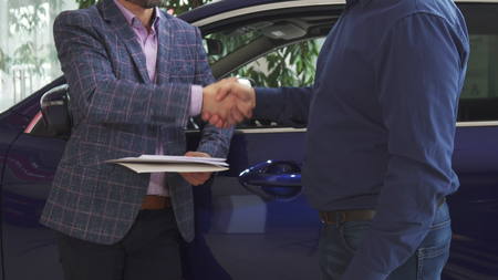 Men sign the agreement to officially confirm the transactionの写真素材