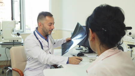 A good doctor prescribes a prescription to the patientの写真素材