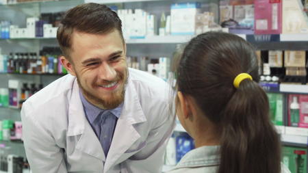 Lovely apothecary gives little girl her purchasesの写真素材