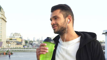 The athletic guy is drinking waterの写真素材