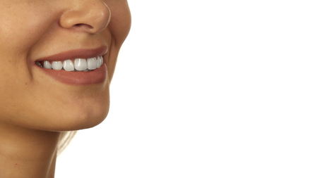 The smiling girl standing on white background