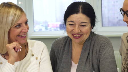 Close up of a senior businesswoman talking to her colelaguesの写真素材