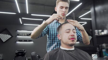 Mature man getting a haircut at the barbershopの写真素材