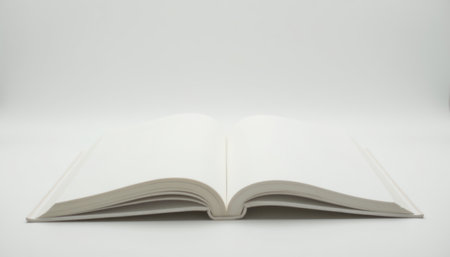 An open blank book placed on a white surface, providing a clean and minimalist look, ideal for design or educational purposes.の素材