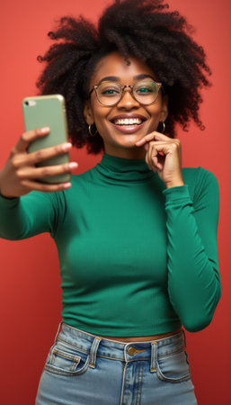 Cheerful woman taking a selfie with a vibrant smileの素材