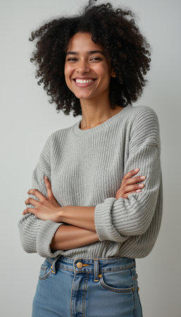 Smiling woman with curly hair in cozy sweaterの素材