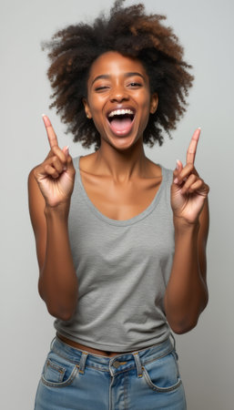 Joyful woman celebrating with raised fingersの素材