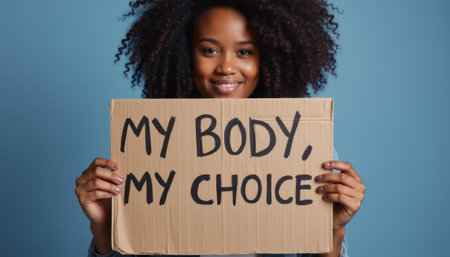 Empowered woman holding a sign reading \"My Body, My Choice\"の素材