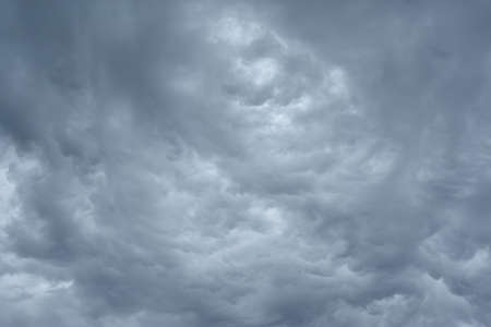 dark grey clouds in the sky before a thunderstorm. Dramatic backdrop or wallpaper. Natural dangerous...