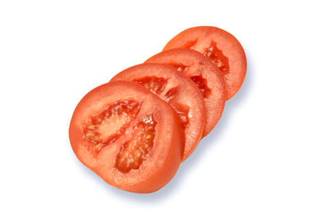 Red tomatos slices isolated on white backgroundの写真素材