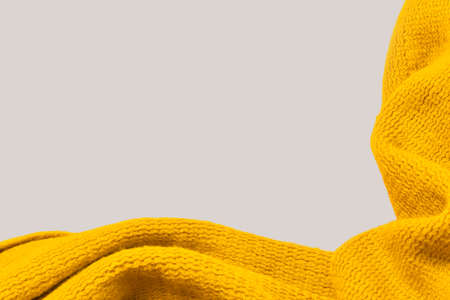 yellow scarf on gray background. cosiness concept. hygge. space for text. card for congratulationsの写真素材