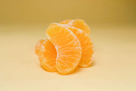 Tangerines slices on yellow backgroundの写真素材