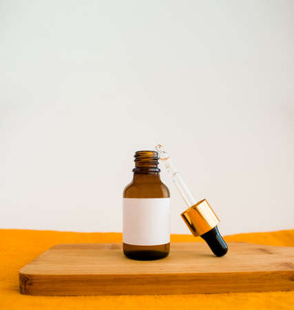 cosmetic dark amber glass bottles. closeup, copyspace. Beauty blogging, salon treatment concept, minimalism brand packaging mock up. mockap. high quality photoの写真素材
