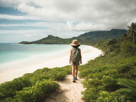 child with a backpack on his shoulders standing on the beach and looking to a sea ??or ocean. High quality photoの素材