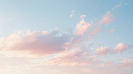 Soft pastel clouds floating in the serene blue sky at sunset time. . High quality photoの素材