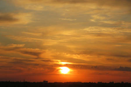 Beautiful fiery golden sunset background in the skyの写真素材