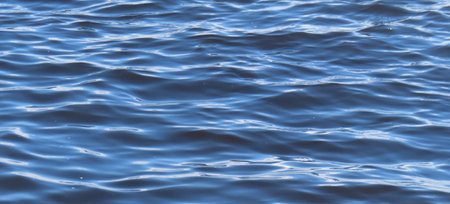 Blue sea water surface background. Close up of rippled water surfaceの写真素材