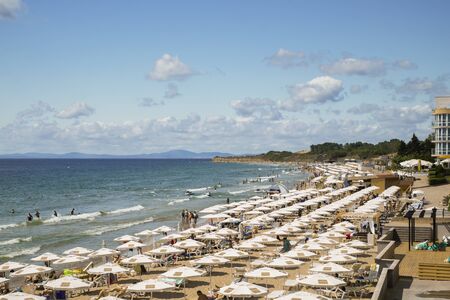 06.25.2018 The resort beach of Nessebar Bulgaria. Sunny day on the Black Sea coast, vacationers swim and sunbathe ...のeditorial素材
