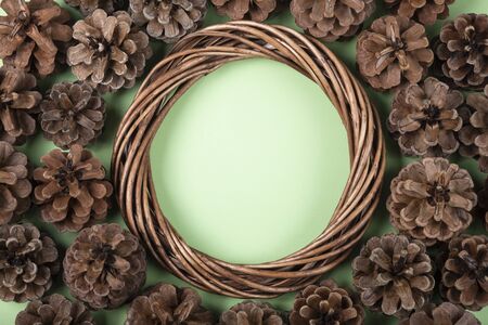 Flat winter layout of braided wreath and fir conesの写真素材