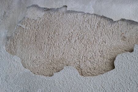 hole in the concrete wall. Gray old wall withfallen off plasterの写真素材