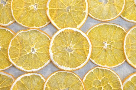 Slices of dried orange on a gray cloth. Fruit backgroundの写真素材