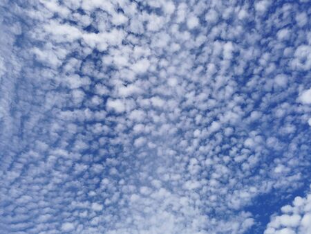 White Cirrus clouds on blue sky on wonderful day.
