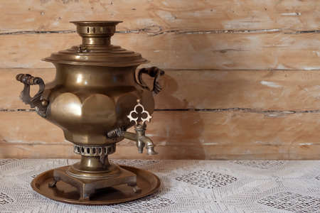 Russian brass samovar antique on a wooden tableの写真素材