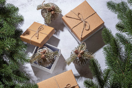 Christmas gift boxes with eco balls surrounded by Christmas tree branchesの写真素材