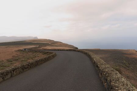 The picturesque and winding road of the Martian coast of Fuertoventura along the coast of the Atlantic oceanの写真素材