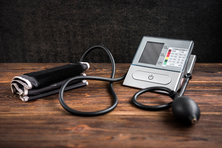 Electronic medical tonometer for measuring blood pressure on wooden tableの写真素材