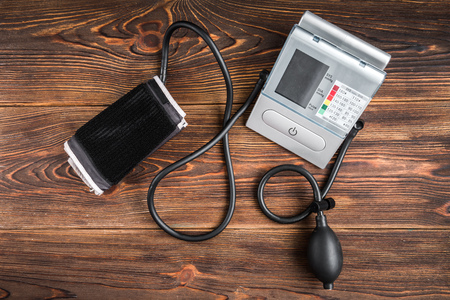 Electronic medical tonometer for measuring blood pressure on wooden tableの写真素材