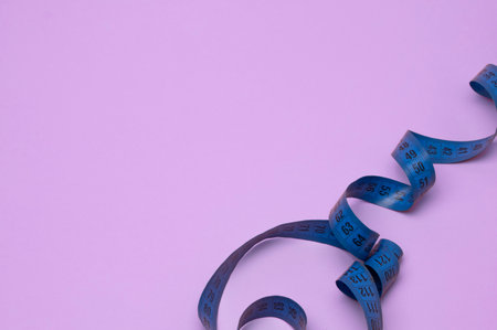 spiral measuring tape on a bright backgroundの写真素材