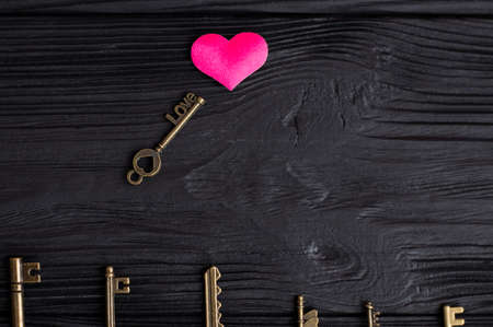 set of antique copper keys. small key with the inscription loveの写真素材