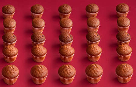 vanilla mini muffins on a red background. Place for your text. Cupcake patternの写真素材