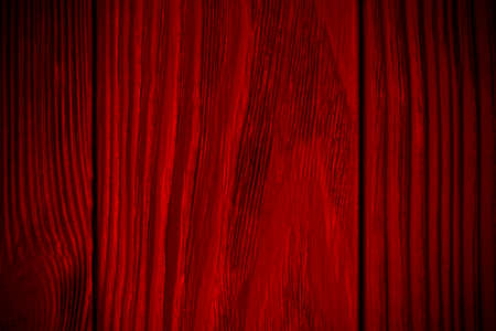 red textured wooden background with black. Vignette. Vintage bright backgroundの写真素材