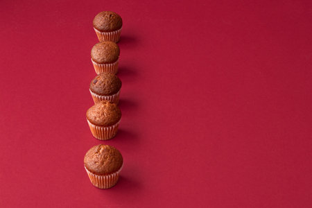 vanilla mini muffins on a red background. Place for your text. Cupcake patternの写真素材